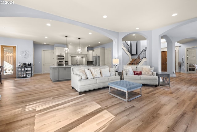 living room featuring light hardwood / wood-style floors and sink