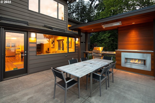 view of patio / terrace with exterior fireplace and area for grilling