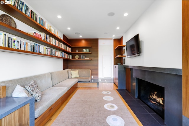 living room with wood walls and dark hardwood / wood-style flooring