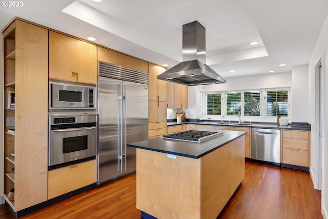 kitchen featuring built in appliances, island exhaust hood, sink, a center island, and dark wood-type flooring