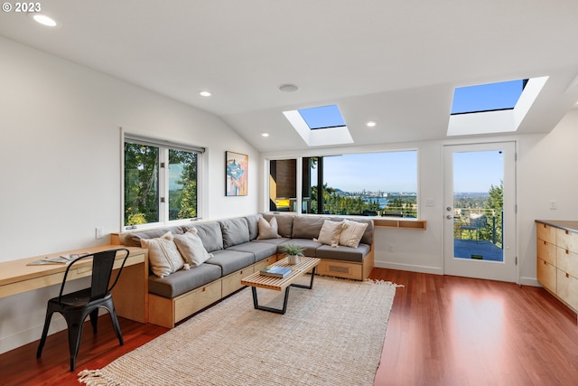 living room featuring lofted ceiling with skylight and dark hardwood / wood-style flooring