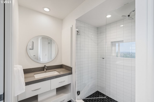 bathroom with vanity and tiled shower