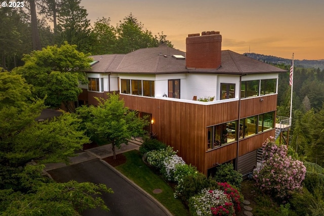 view of back house at dusk