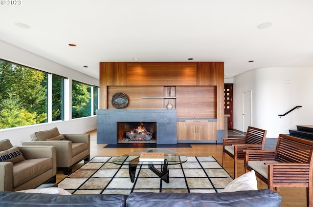 living room featuring light hardwood / wood-style floors and a tile fireplace