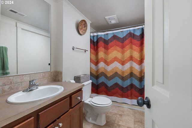 bathroom with decorative backsplash, toilet, ornamental molding, tile patterned floors, and vanity