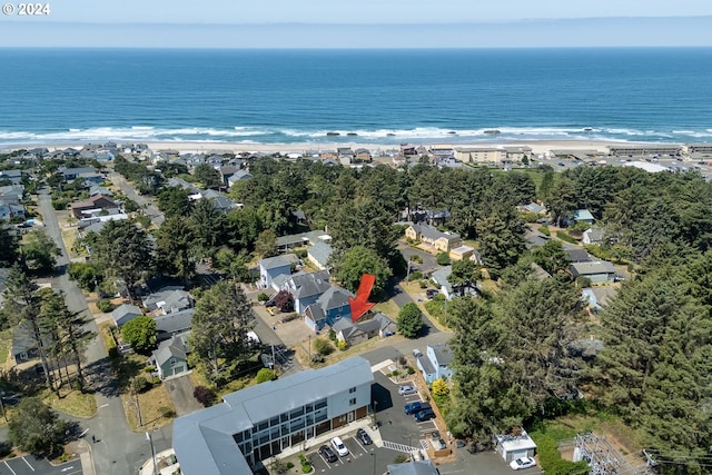 bird's eye view featuring a water view and a beach view