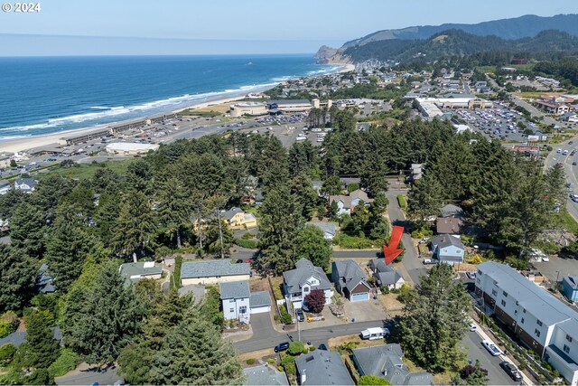 birds eye view of property featuring a beach view and a water and mountain view