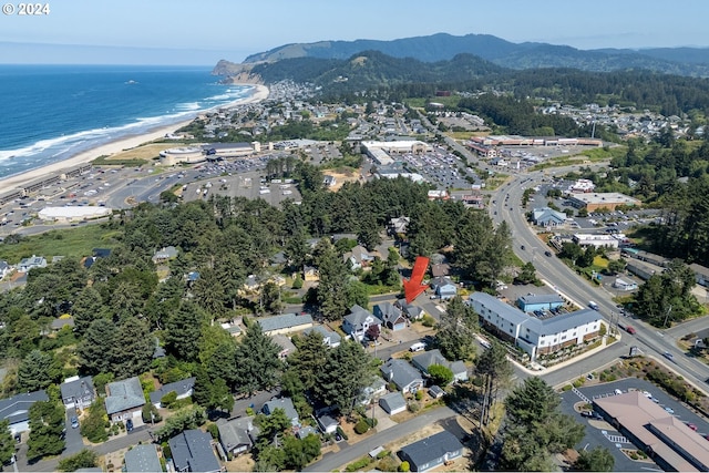 aerial view with a water and mountain view and a view of the beach