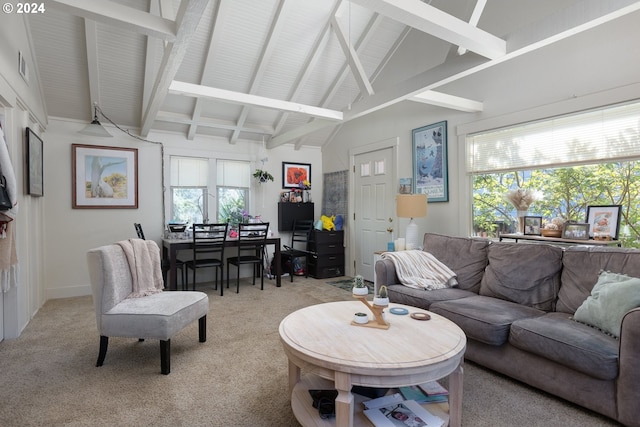 carpeted living room featuring lofted ceiling with beams