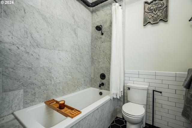 bathroom featuring shower / tub combo with curtain, tile walls, and toilet