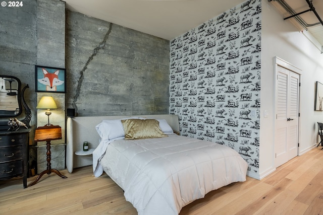 bedroom featuring a closet and light hardwood / wood-style floors