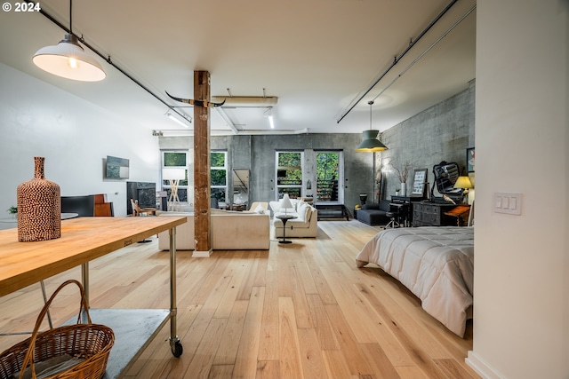 bedroom featuring french doors and light wood-type flooring