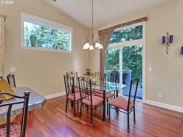 dining area featuring dark wood-type flooring, baseboards, a chandelier, and vaulted ceiling