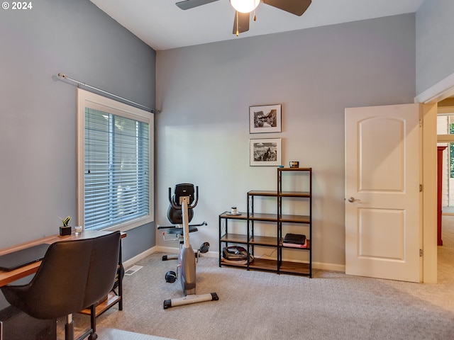 exercise area featuring carpet floors, baseboards, and a ceiling fan