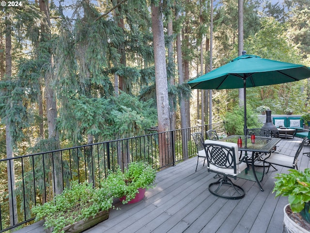 wooden terrace featuring outdoor dining area