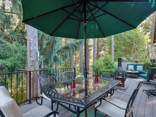 deck featuring outdoor dining area and an outdoor hangout area