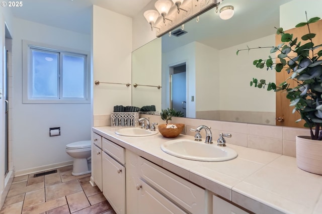 14940 SW 103rd Ave, Portland, OR 97224 - bathroom featuring double vanity, visible vents, a sink, and toilet
