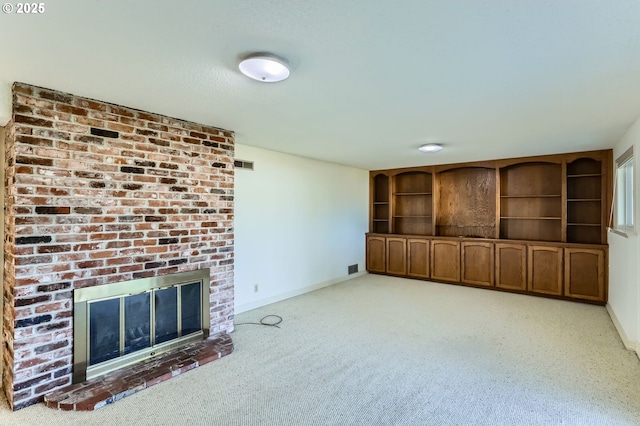 14940 SW 103rd Ave, Portland, OR 97224 - unfurnished living room with a fireplace, baseboards, visible vents, and carpet floors