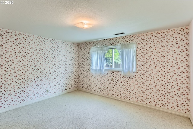 14940 SW 103rd Ave, Portland, OR 97224 - carpeted spare room featuring visible vents, baseboards, wallpapered walls, and a textured ceiling