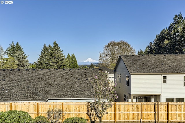 14940 SW 103rd Ave, Portland, OR 97224 - view of home's exterior with a mountain view, a shingled roof, and fence