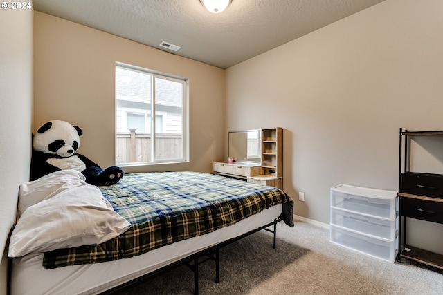 carpeted bedroom with a textured ceiling