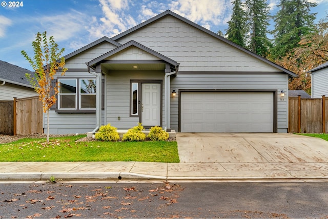 view of front of property featuring a garage and a front yard