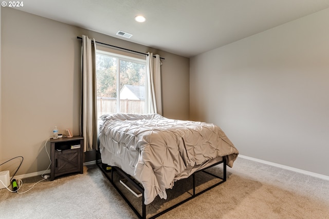 bedroom featuring light colored carpet