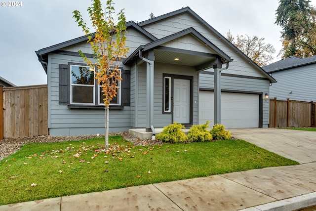 view of front of house featuring a garage and a front yard