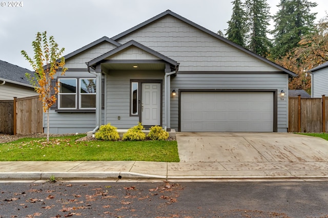 view of front of property with a garage and a front lawn