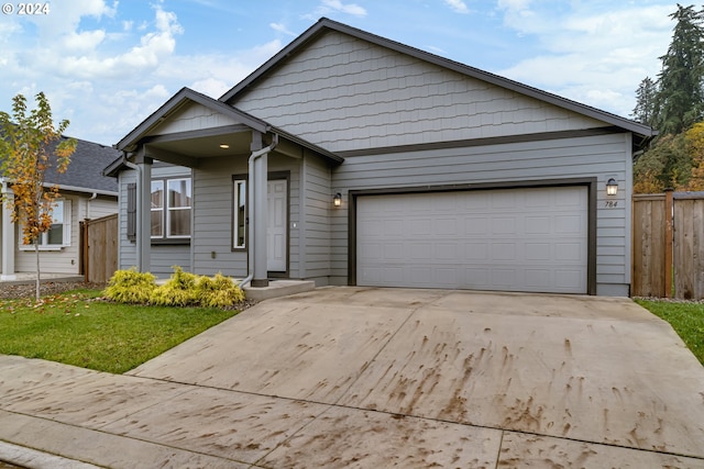 view of front of house featuring a garage and a front lawn