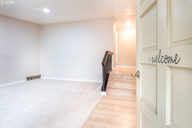 staircase featuring hardwood / wood-style floors