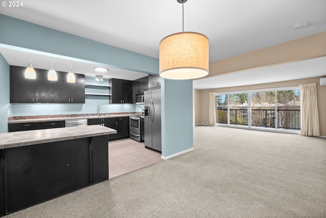 kitchen featuring pendant lighting, light colored carpet, sink, and appliances with stainless steel finishes