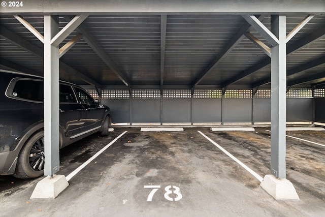 view of parking / parking lot featuring a carport