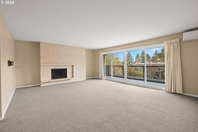 unfurnished living room with a fireplace, carpet, and a wall mounted air conditioner