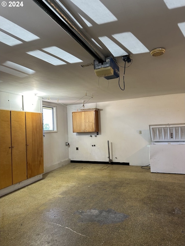 garage with baseboards and a garage door opener