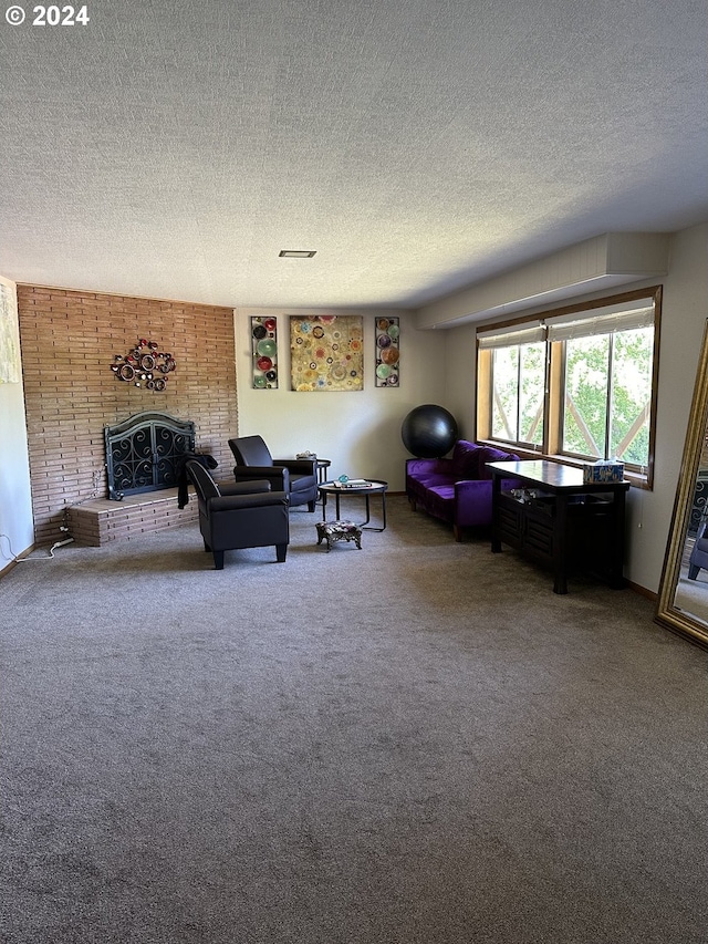 carpeted living area featuring a fireplace and a textured ceiling