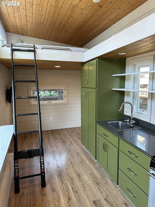 kitchen featuring sink, green cabinetry, light hardwood / wood-style floors, and wooden ceiling