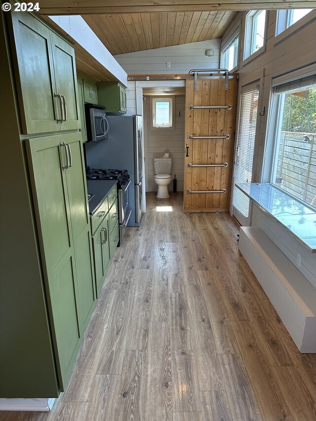 interior space with green cabinets, stainless steel appliances, hardwood / wood-style floors, and wood ceiling