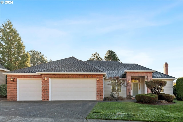 view of front of property with a front yard and a garage