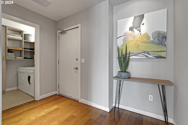 interior space featuring washer and clothes dryer and wood-type flooring