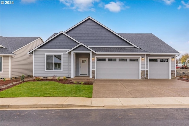 craftsman-style house with a front yard and a garage