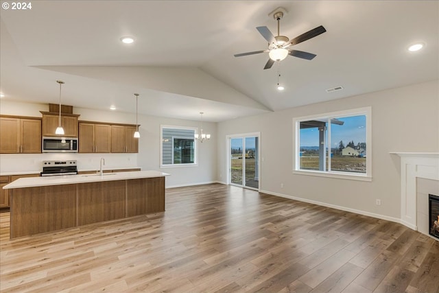 unfurnished living room with light hardwood / wood-style flooring, ceiling fan with notable chandelier, lofted ceiling, and sink