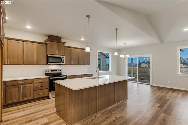 kitchen featuring a wealth of natural light, sink, stainless steel appliances, and lofted ceiling