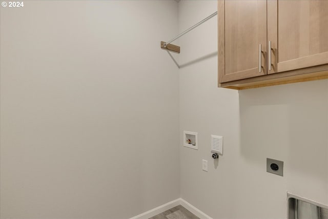 washroom featuring cabinets, washer hookup, hardwood / wood-style flooring, and hookup for an electric dryer