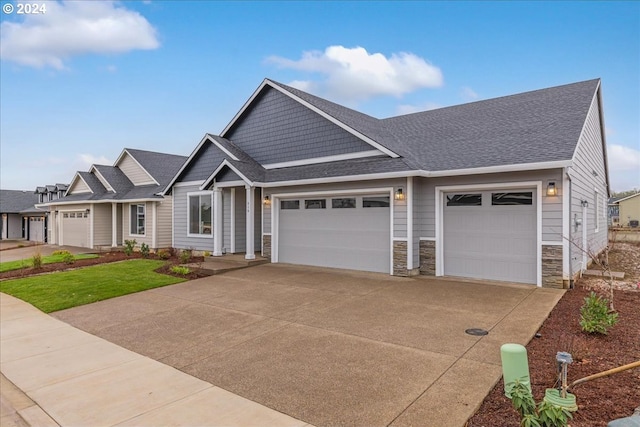 craftsman house featuring a front yard and a garage