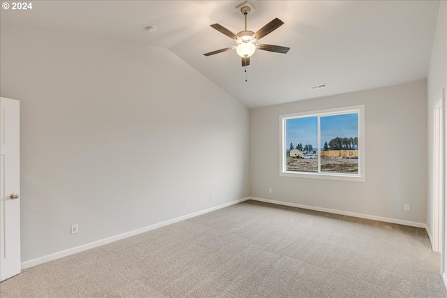 carpeted spare room featuring ceiling fan and lofted ceiling