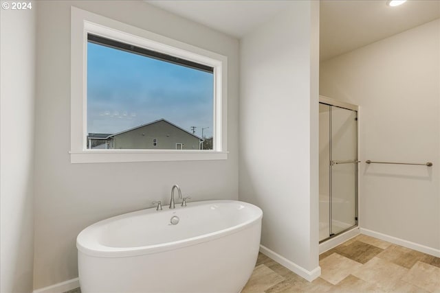 bathroom with a healthy amount of sunlight and plus walk in shower