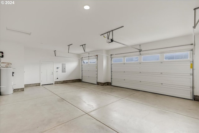 garage featuring electric panel, a garage door opener, and water heater