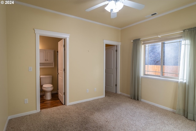 unfurnished bedroom with ensuite bathroom, ceiling fan, and light colored carpet