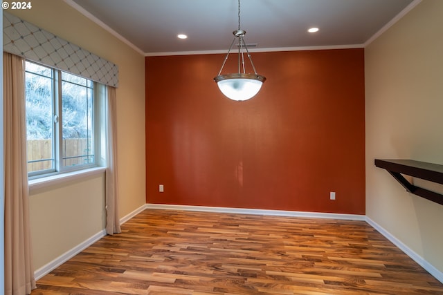 unfurnished dining area with wood-type flooring and ornamental molding